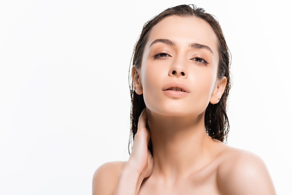 Woman after shower with beautiful skin looking at the camera